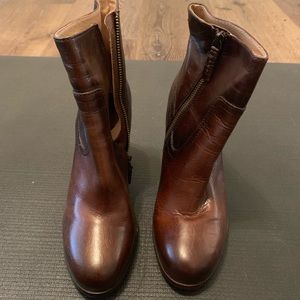 Rounded toe heeled FRYE boots.